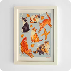 Stampa incorniciata raffigurante dei gatti, dei cappelletti e una coppia di pane su fondo azzurro